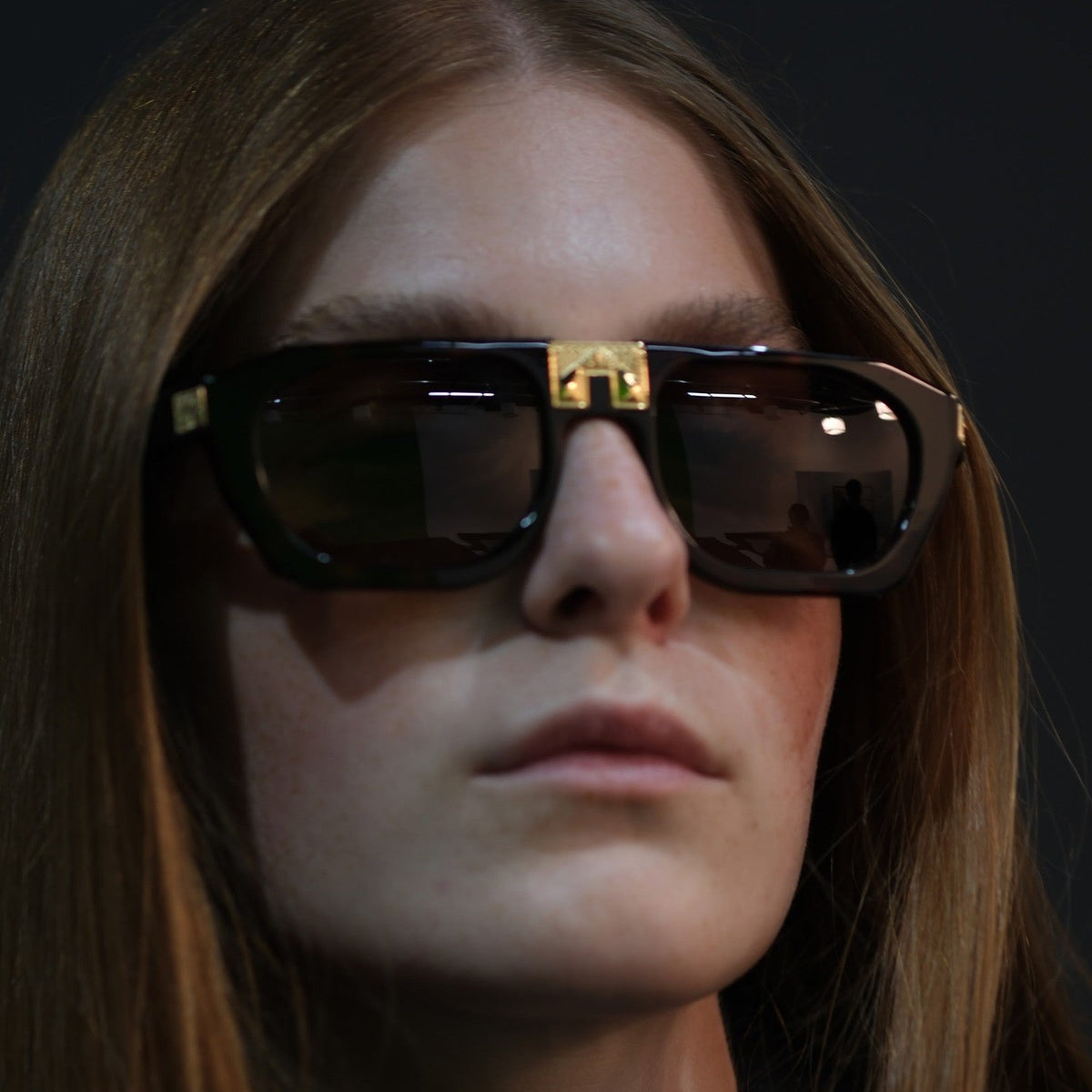 Model wearing ARIA NOIR Monarca sunglasses in Noir black acetate with gold bridge detail
