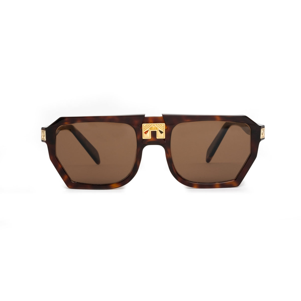 A pair of sunglasses with dark tortoise patterned frames and gold accents, including a gold engraved detail on the front.