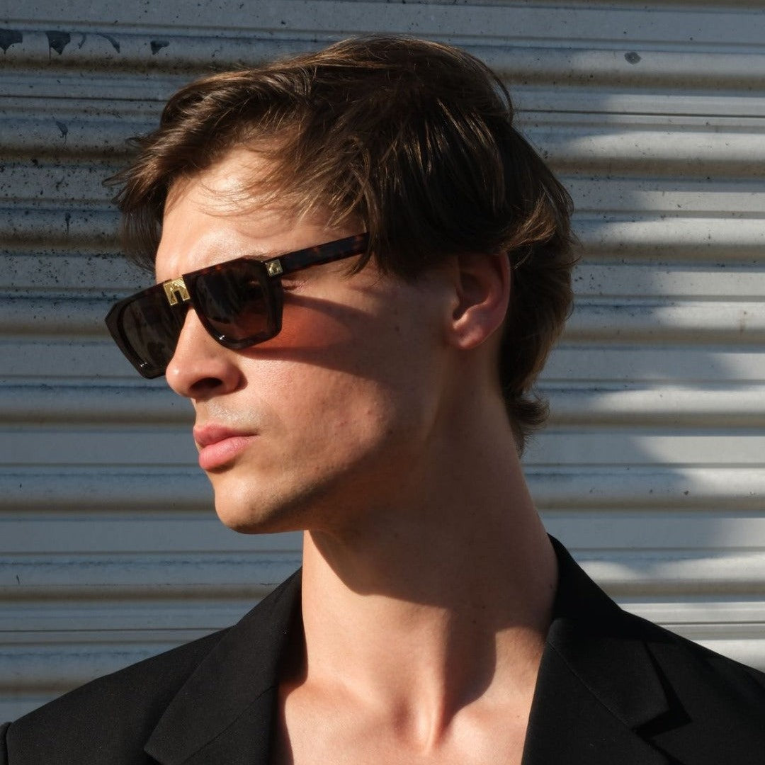 Model wearing ARIA NOIR Monarca sunglasses in Dark Tortoise acetate with gold bridge detail