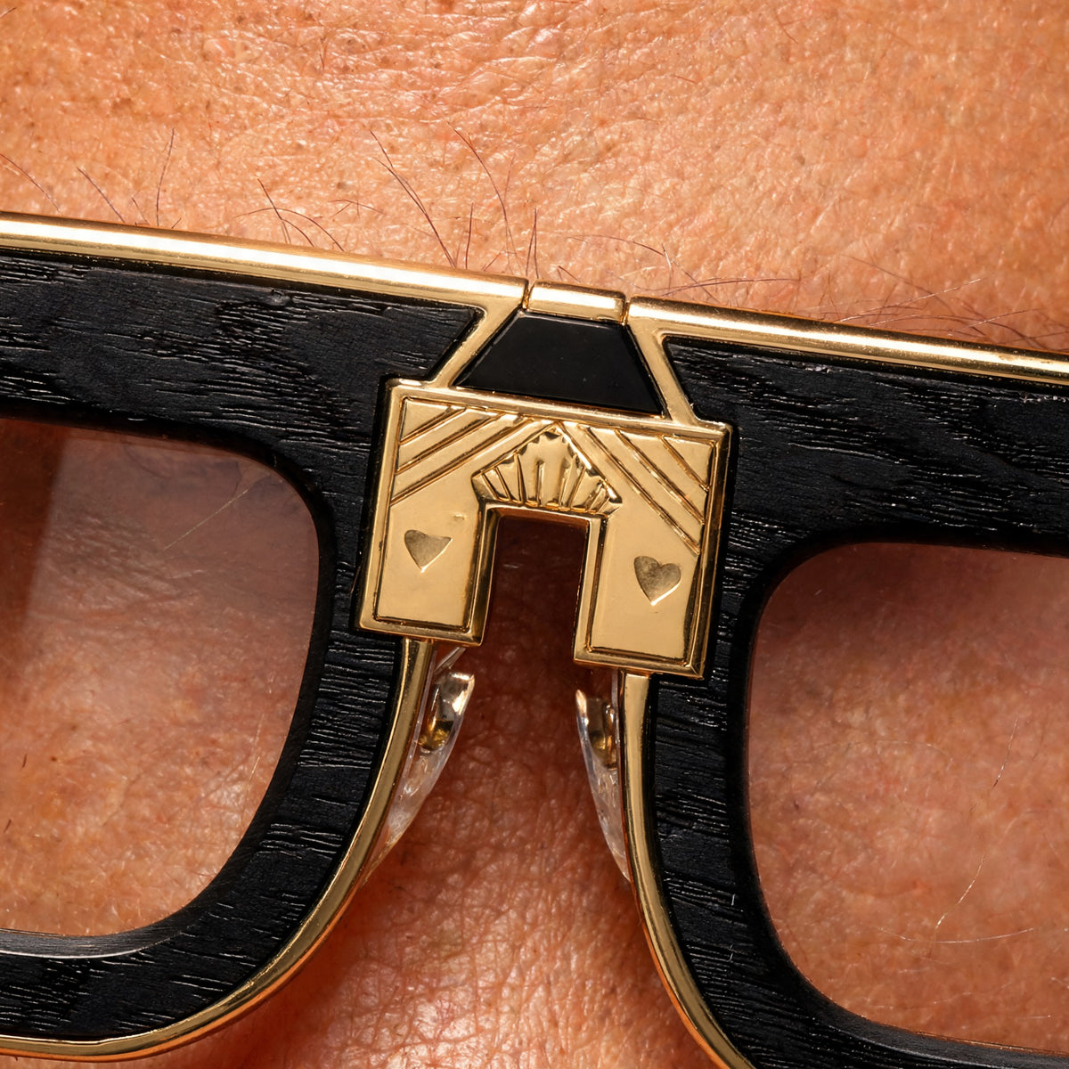 ARIA NOIR Matriarca eyewear in Black Wood, close up of the gold bridge detail